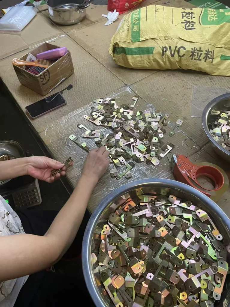Batch consistency check sorting stamped motorcycle parts before packaging