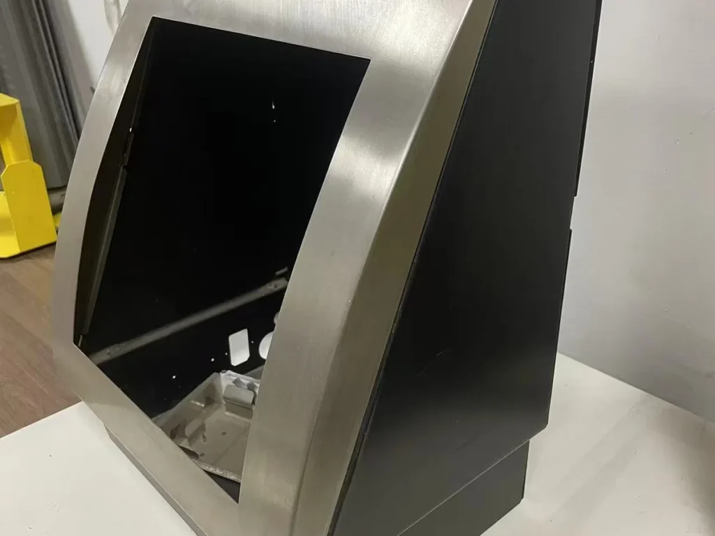 Stainless steel sink panel 45-degree side view showing curved face profile and black base housing assembly