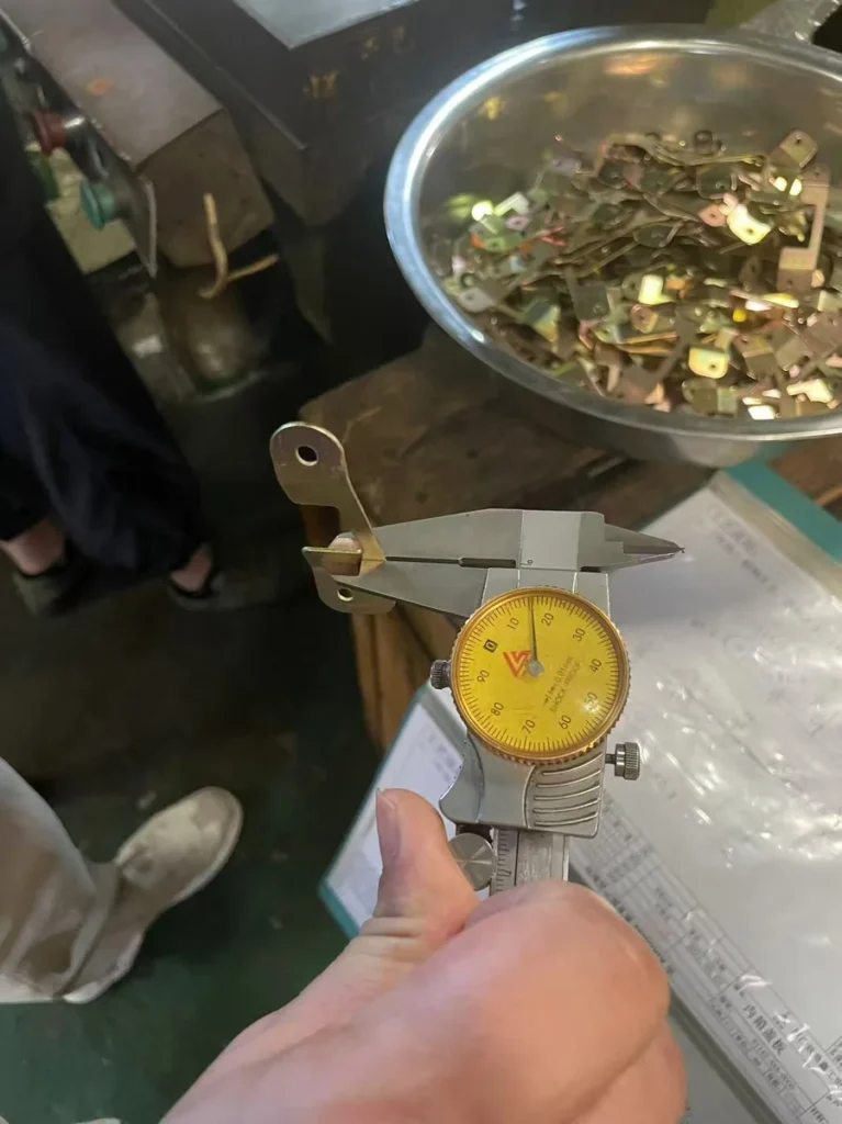 dimensional inspection of progressive die stamped part with calipers