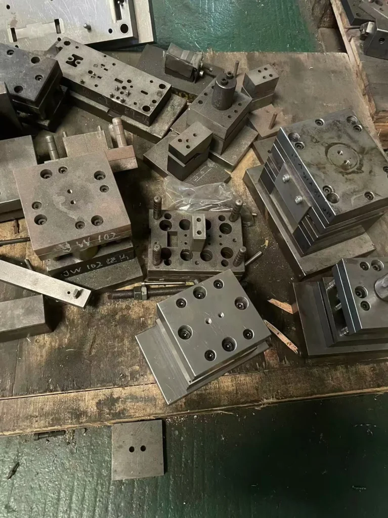 Disassembled stamping die components laid out for inspection and repair