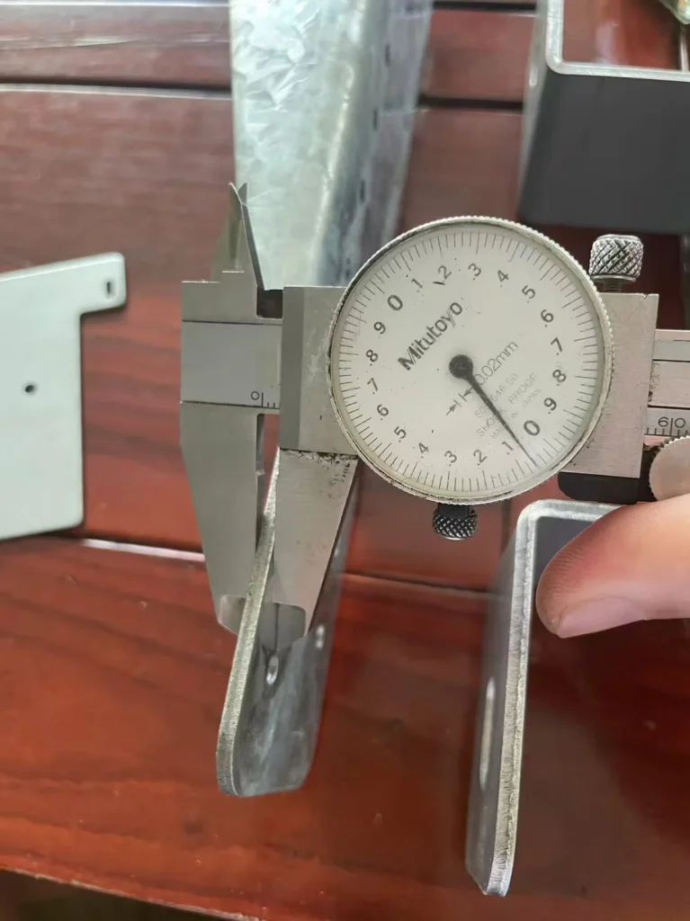 Caliper measuring thickness of regular spangle galvanized bracket