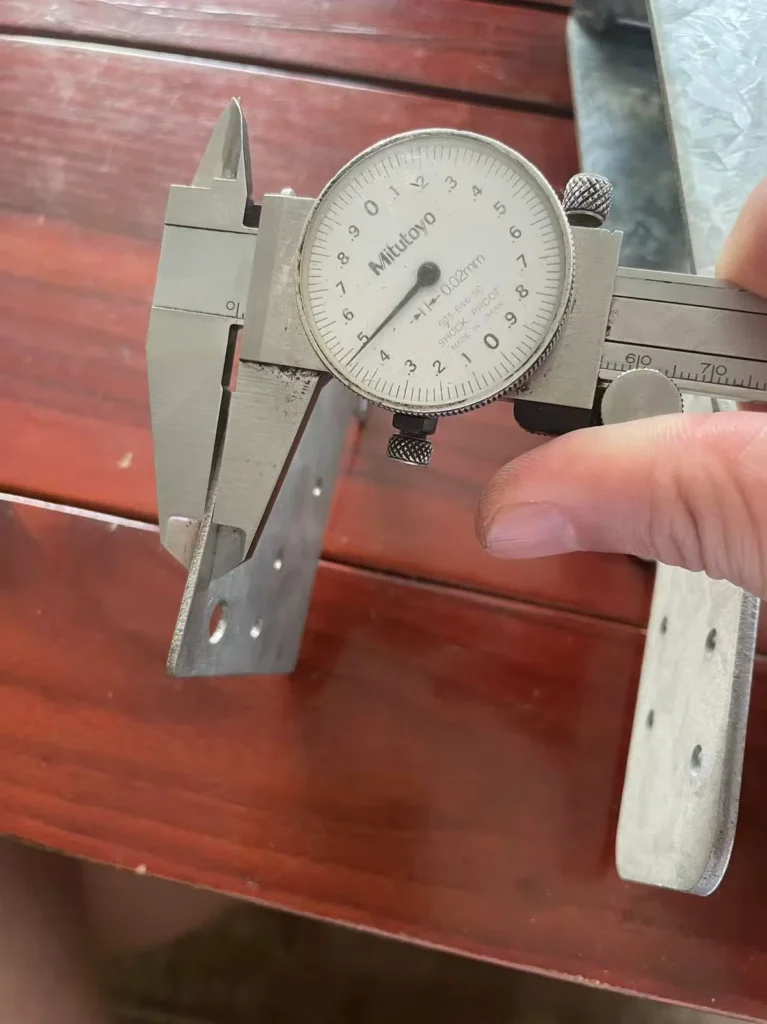 Caliper measuring thickness of zero spangle galvanized bracket