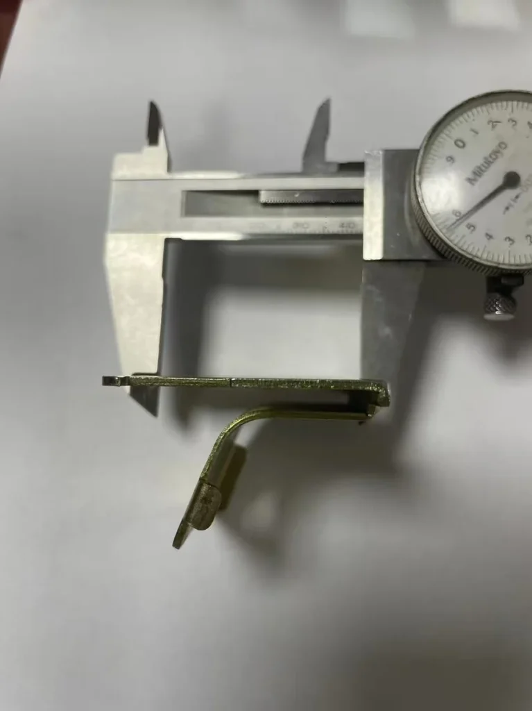 Caliper measuring bend angle on stamped motorcycle bracket