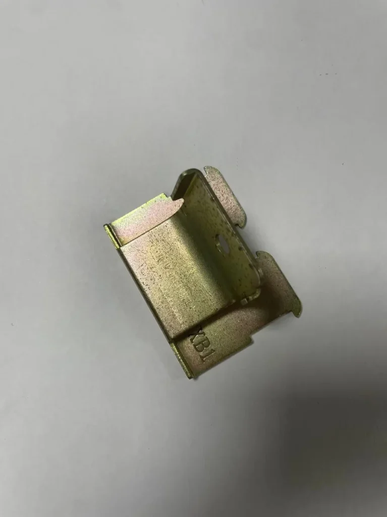 Rear view of stamped motorcycle bracket showing forming detail