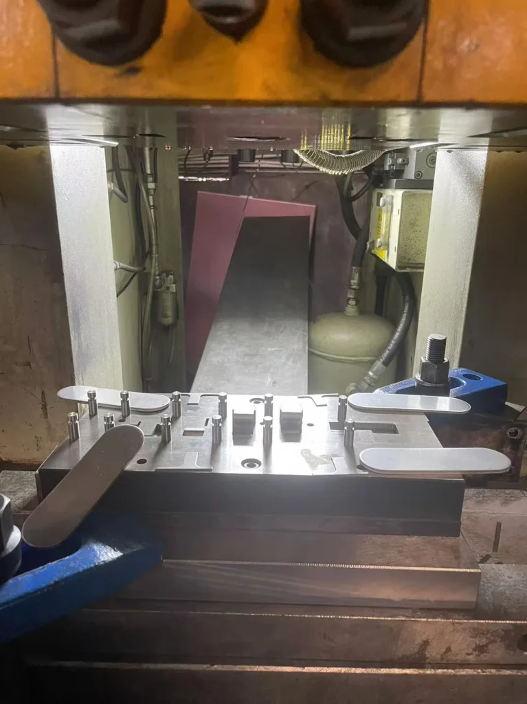 What is metal stamping — progressive die press with coil feed at Metal Stamp Factory
