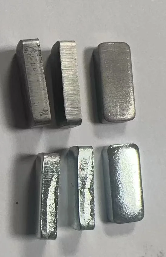 Cross-section of stamped metal blocks showing shear and fracture zone before and after plating