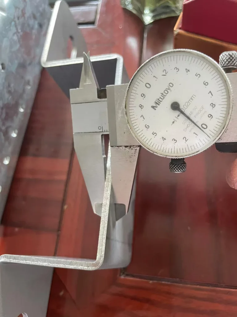 Caliper measuring thickness of zinc-aluminum-magnesium coated bracket