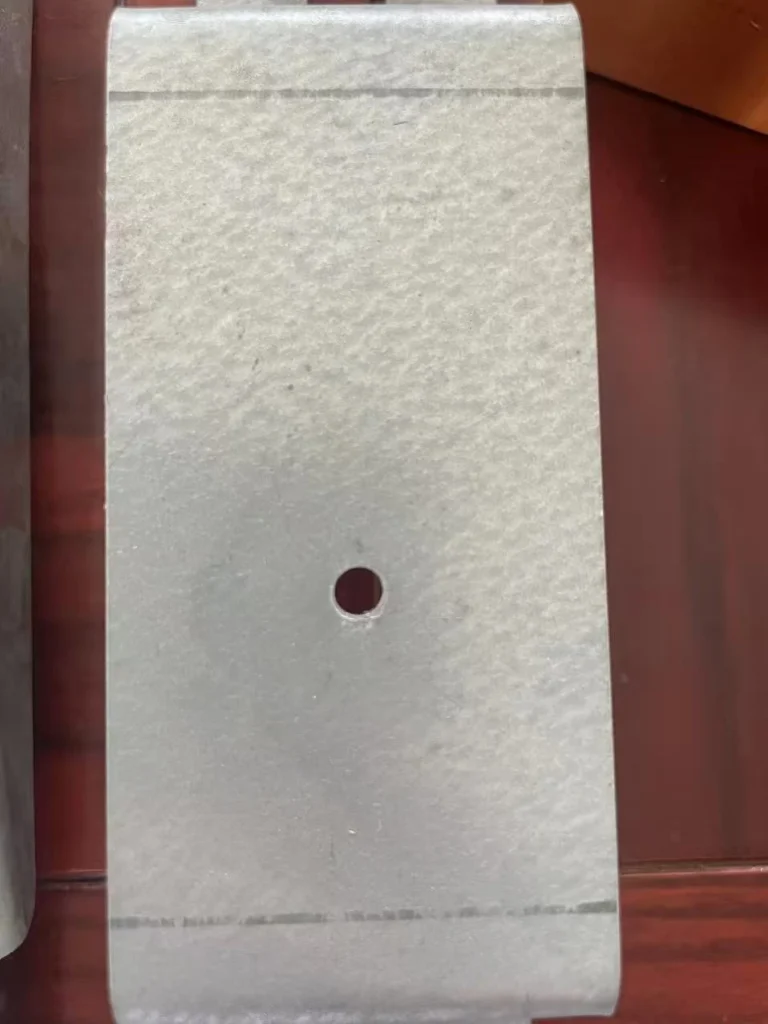 Zinc-aluminum-magnesium coated steel surface close-up